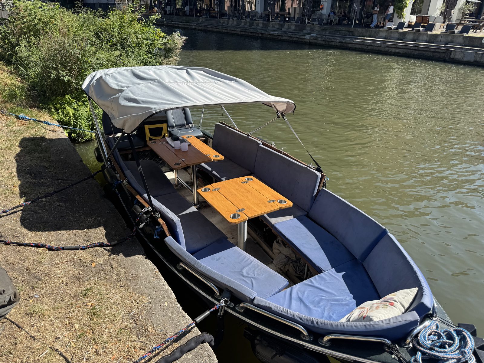 Das Boot mit aufgespanntem Bimini-Verdeck, vom Kai aus gesehen